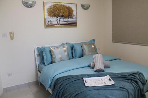 a bedroom with a blue bed with a sign on it at Newly furnished 1 Bedroom, high floor, amazing view, close to metro in Dubai