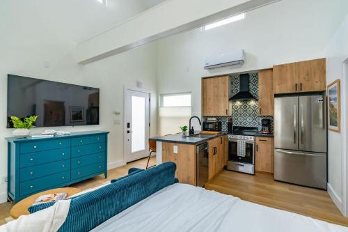 a large kitchen with a blue couch in a room at Swanky Studio in Vibrant Hillcrest in San Diego