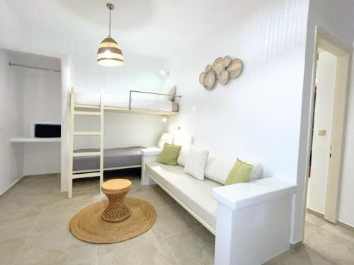 a living room with a couch and a bunk bed at Thea Suites Naxos in Agios Prokopios