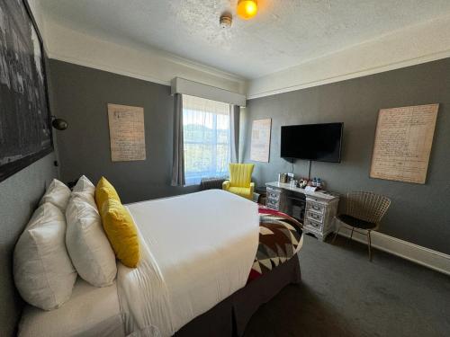 フッド・リバーにあるHood River Hotelのベッドとテレビのある寝室