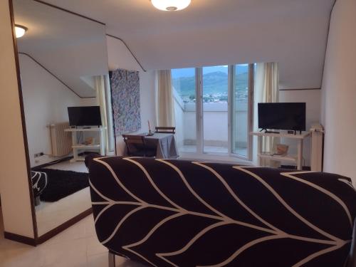 a hotel room with a bed and a large window at Appartamento Monique in Pieve di Soligo