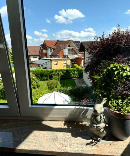 a statue of a rabbit sitting in front of a window at Ferienwohnung Pracht - großzügige FeWo ab 75 qm in Rust