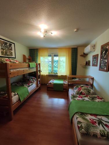 a room with three bunk beds and a window at Haus Am Ölberg in Karsau