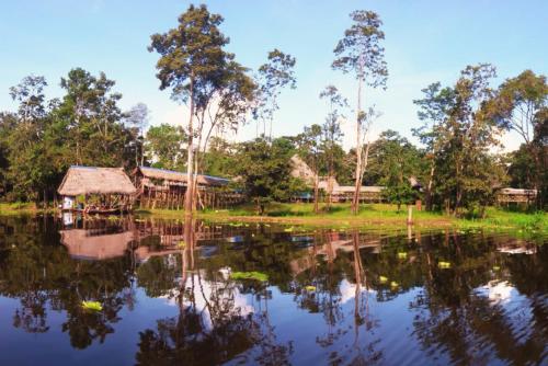 a village next to a body of water at Amazon Curassow Lodge and Expeditions in Paraíso