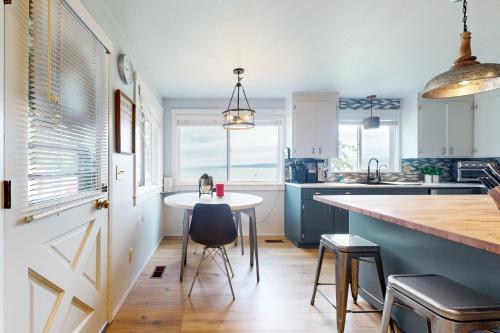 a kitchen with a table and chairs and a counter at Three Eagles On Whidbey in Freeland
