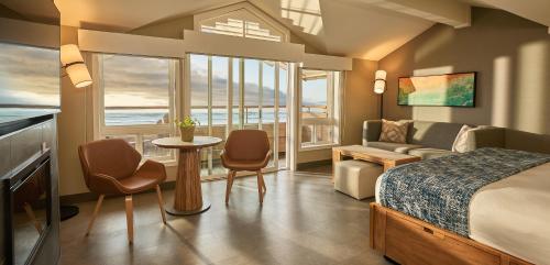 a bedroom with a bed and a table and chairs at Surfsand Resort in Cannon Beach
