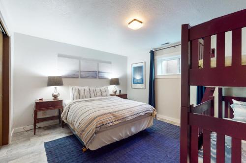 a bedroom with a bed and a ladder and a bunk bed at Three Eagles On Whidbey in Freeland