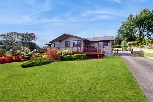 a home with a large yard with a house at Three Eagles On Whidbey in Freeland