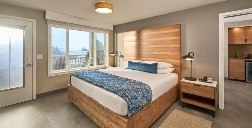 a bedroom with a bed and a large window at Surfsand Resort in Cannon Beach