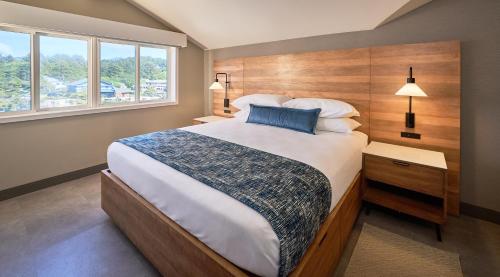 a bedroom with a large bed and a window at Surfsand Resort in Cannon Beach