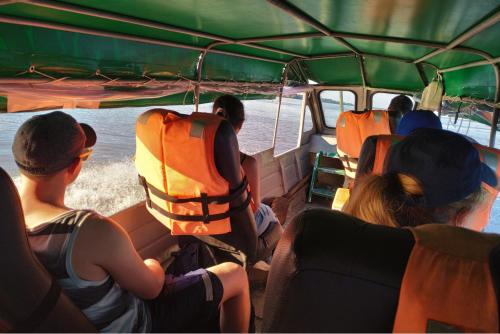 a group of people sitting in the back of a bus at Amazon Curassow Lodge and Expeditions in Paraíso
