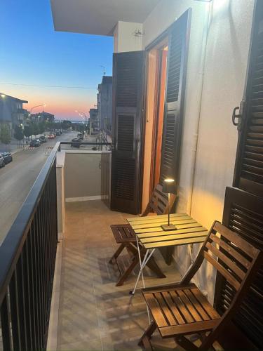 a patio with a table and chairs on a balcony at Sea Gargano Home in Poggio Imperiale