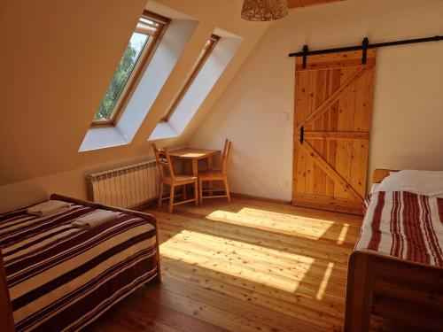 a bedroom with a bed and a table and a barn door at Michniowiec 6 in Czarna