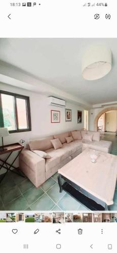 a living room with a couch and a coffee table at Lefkada Eli's amazing beach house in Nikiana
