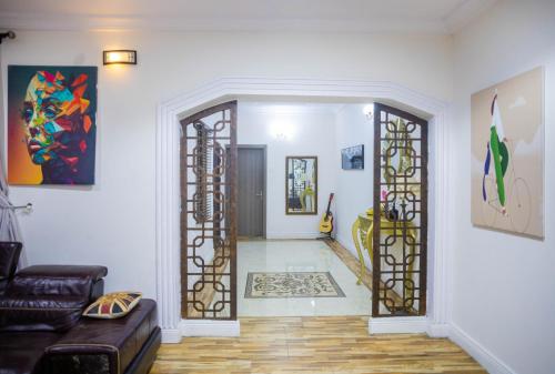 an open door into a living room with a couch at LEKKI SECRET MANSION 'n' SWIMMING POOl in Aja