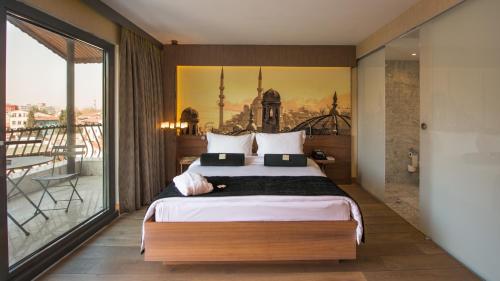 a bedroom with a large bed and a balcony at Hotel Saint Sophia in Istanbul