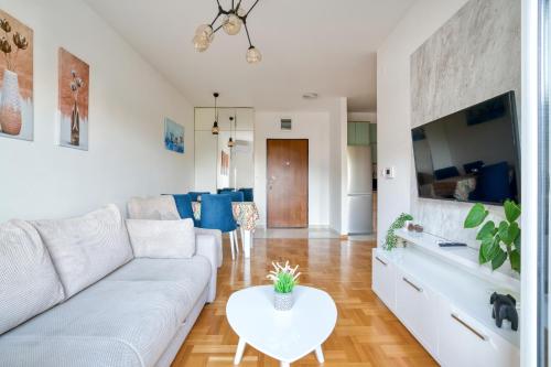a living room with a couch and a table at Azure Apartments in Budva