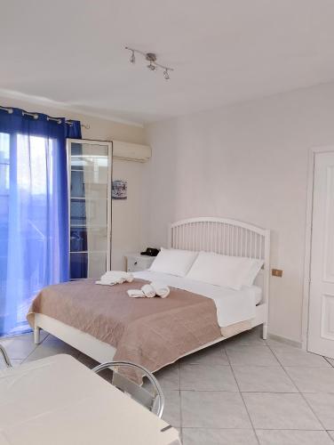a bedroom with a bed with two towels on it at Sea life Terrasini in Terrasini