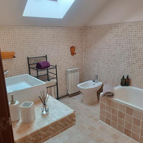 a bathroom with a tub and a toilet and a sink at R2R - Apartmento Aire del Mar - C11A02 in Liencres
