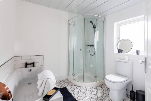 a white bathroom with a shower and a toilet at Homey 4 Br Near The City Gateshead&newcastle in Dunston