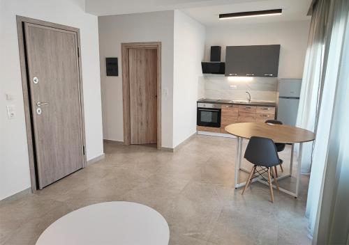 a kitchen with a table and a table and chairs at K78 Studios A1 in Nea Michaniona