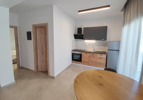 a kitchen with a wooden table in a room at K78 Studios A1 in Nea Michaniona