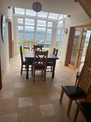 a dining room with a table and some chairs at 10 Harbourside in Downings