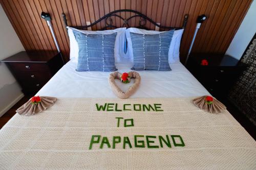 a bed with a welcome to parrespond sign on it at PAPAGENO RESORT & DIVE in Kadavu