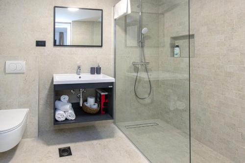 a bathroom with a shower and a sink and a toilet at Villa Mare in Vinišće