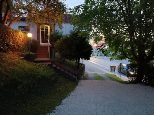 a house on a street with a driveway at Prenociste Cazin in Cazin