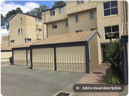 a large garage with a building in the background at Dana-Private Room in 3-Bedroom Apartment 2 in Canberra