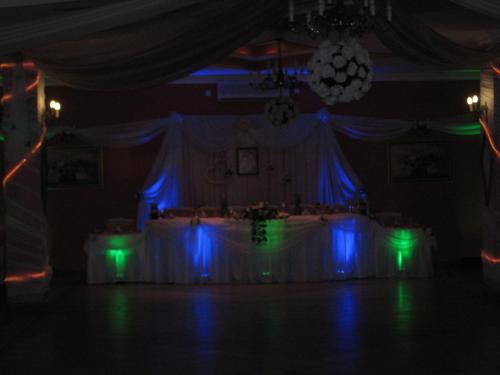 a room with a table with blue and green lights at Zajazd Skalny in Ostrów Mazowiecka