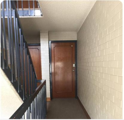 a hallway with a wooden door and a staircase at Dana-Private Room in 3-Bedroom Apartment 2 in Canberra
