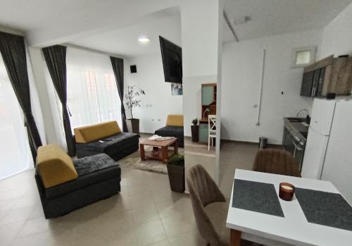 a living room with a couch and a table at Apartman predah Vranje FREE PARKING U SKLOPU JEDINICE in Vranje