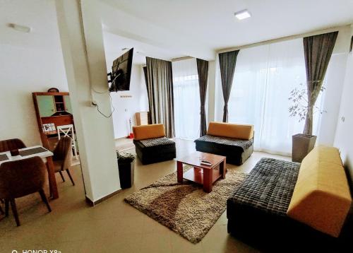 a living room with a couch and chairs and a table at Apartman predah Vranje FREE PARKING U SKLOPU JEDINICE in Vranje