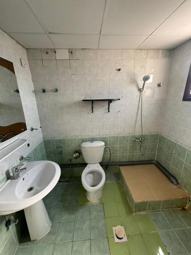 a bathroom with a toilet and a sink at LARGE M BEDROOM Attached Bathroom with Terrace Access in a villa Sharjah in Sharjah