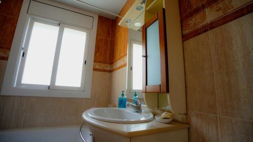a bathroom with a sink and a mirror at La Casa de Mima in Cubelles