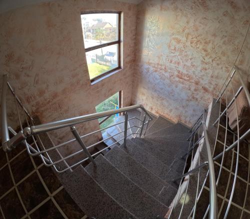 a staircase in an old building with a window at Elite Hotel Kobuleti in K'obulet'i