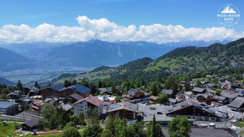 a town in a valley with mountains in the background at Moo-ntain Suite by Villars Luxury in Villars-sur-Ollon