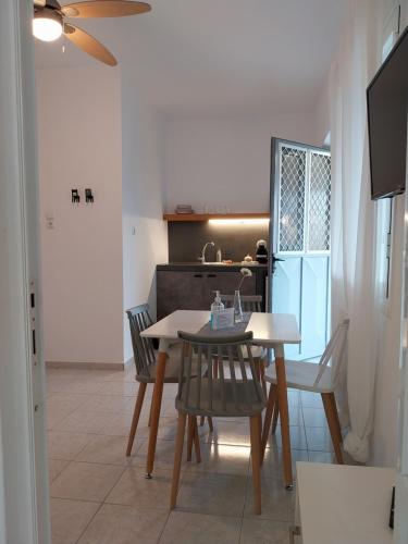 a kitchen and dining room with a table and chairs at Galini Rooms & Apartments in Finikas