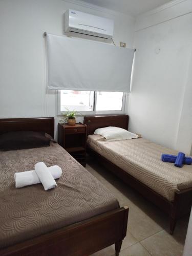 a bedroom with two beds with towels on them at Camba Cua Relax in Corrientes