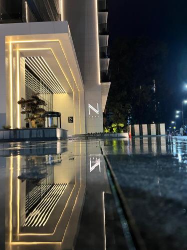 a building with a swimming pool at night at Next Apartments Batumi with Sea View in Batumi