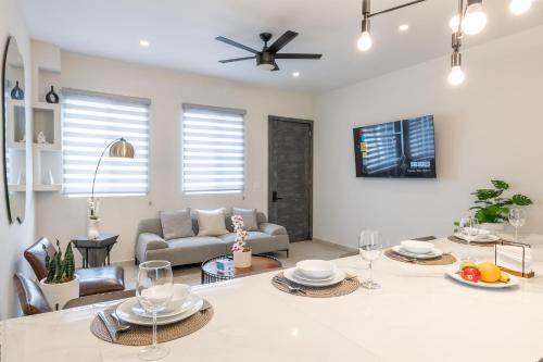 a living room with a table and a couch at New Casa San Felipe with Gated Parking at Casas Sanblu in Ensenada
