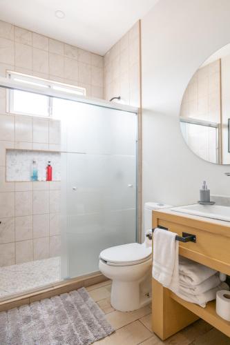a bathroom with a shower and a toilet and a sink at New Casa San Felipe with Gated Parking at Casas Sanblu in Ensenada