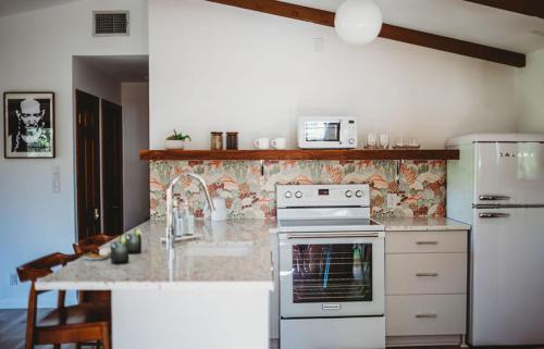 a kitchen with a stove and a counter top at Hideout Cabin - private retreat just 15 mins from Wimberley! in Wimberley