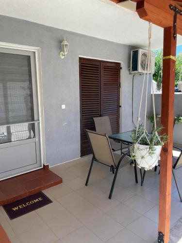 a balcony with a table and chairs in a room at TIKI Apartments in Gevgelija