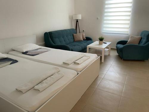 a living room with two beds and a couch at TIKI Apartments in Gevgelija