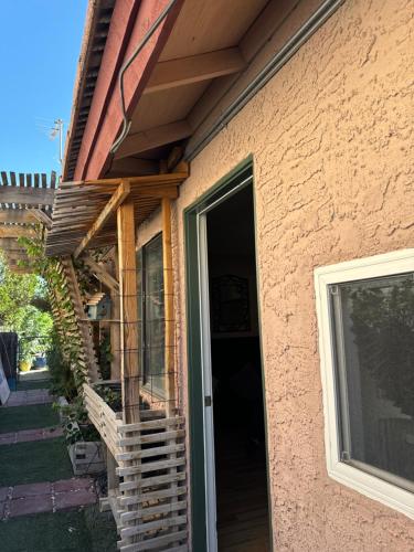 a porch of a house with a glass door at Le Noir, A private bedroom with a private entrance - shared bathroom in Las Vegas