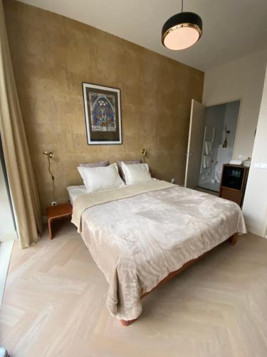 a bedroom with a large bed in a room at Gorgeous room near Haarlem Station, city center in Haarlem