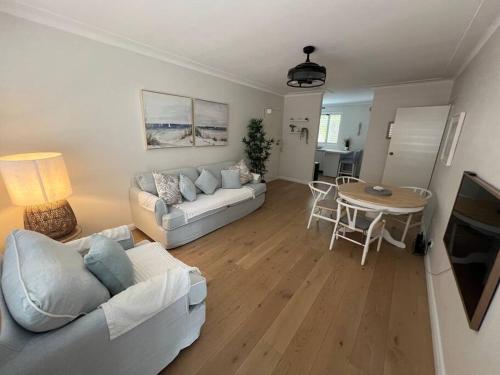a living room with a couch and a table at Sunny boutique apartment in Sydney